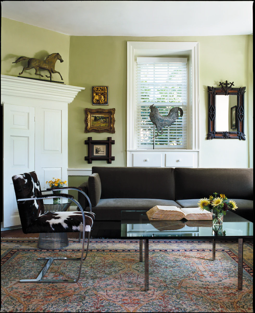 Glass table with metal legs, books and bowls arranged on top