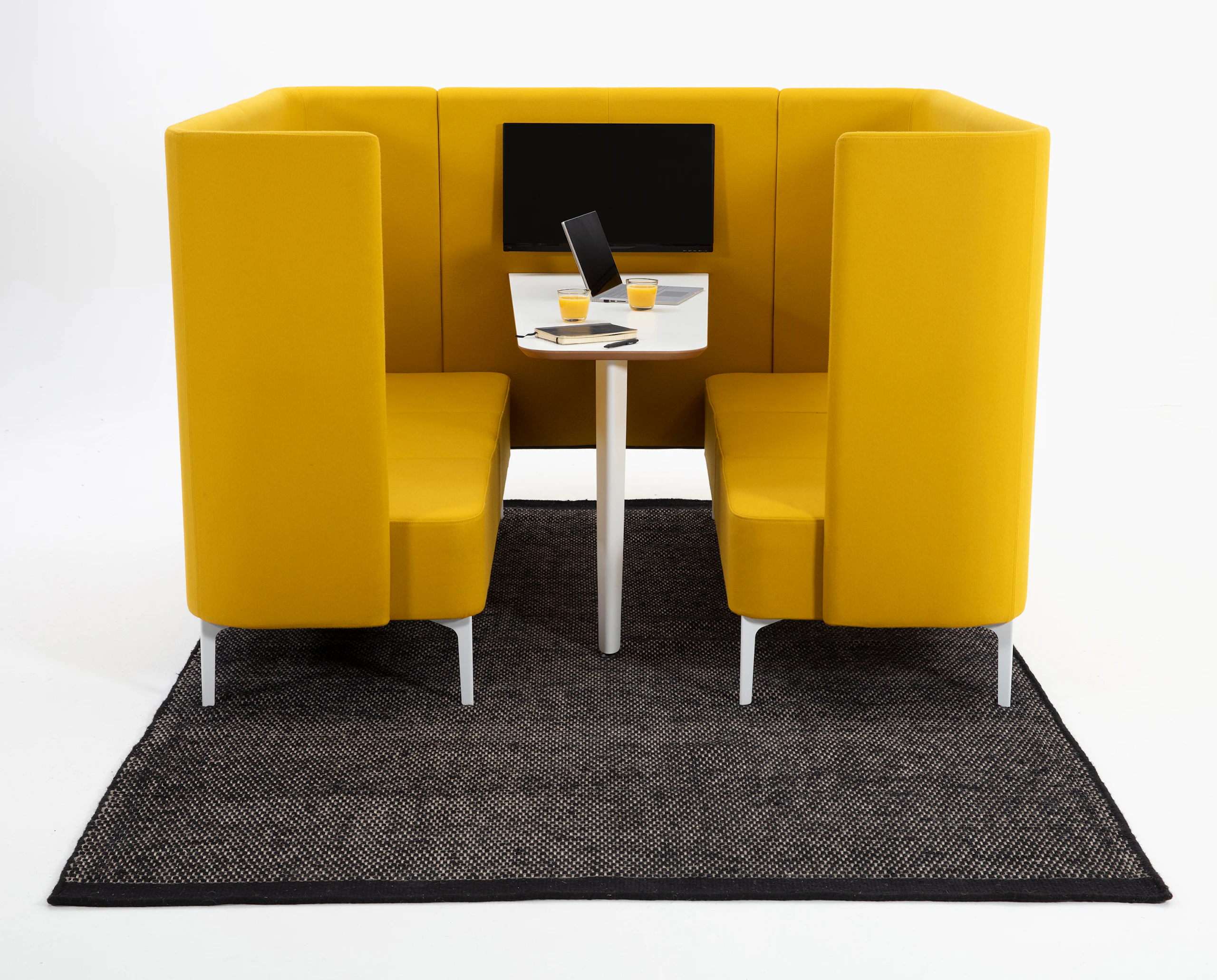 6 seat Pullman Booth upholstered in yellow fabric, with white metal feet and a white mfmdf table top and tv screen.