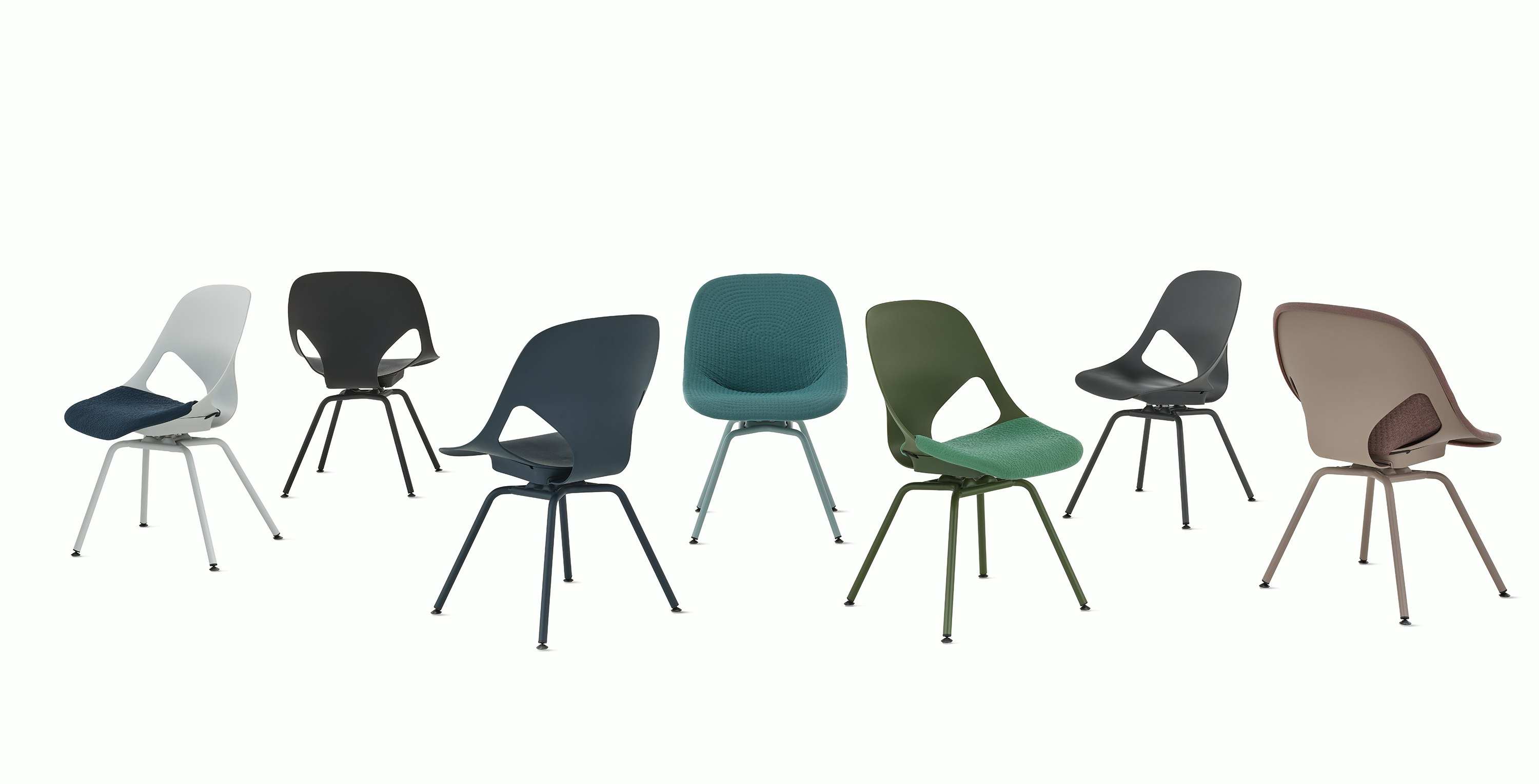 A group of seven Zeph side chairs without arms in all available colors . Some chairs have knit seat pads and unibody's.