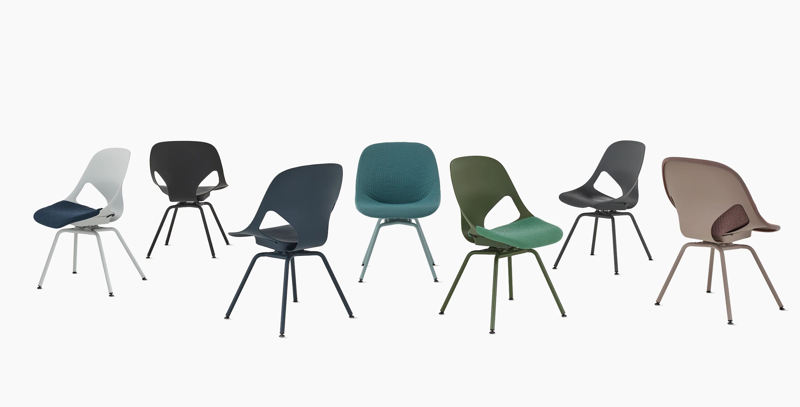 A group of seven Zeph side chairs without arms in all available colors . Some chairs have knit seat pads and unibody's.