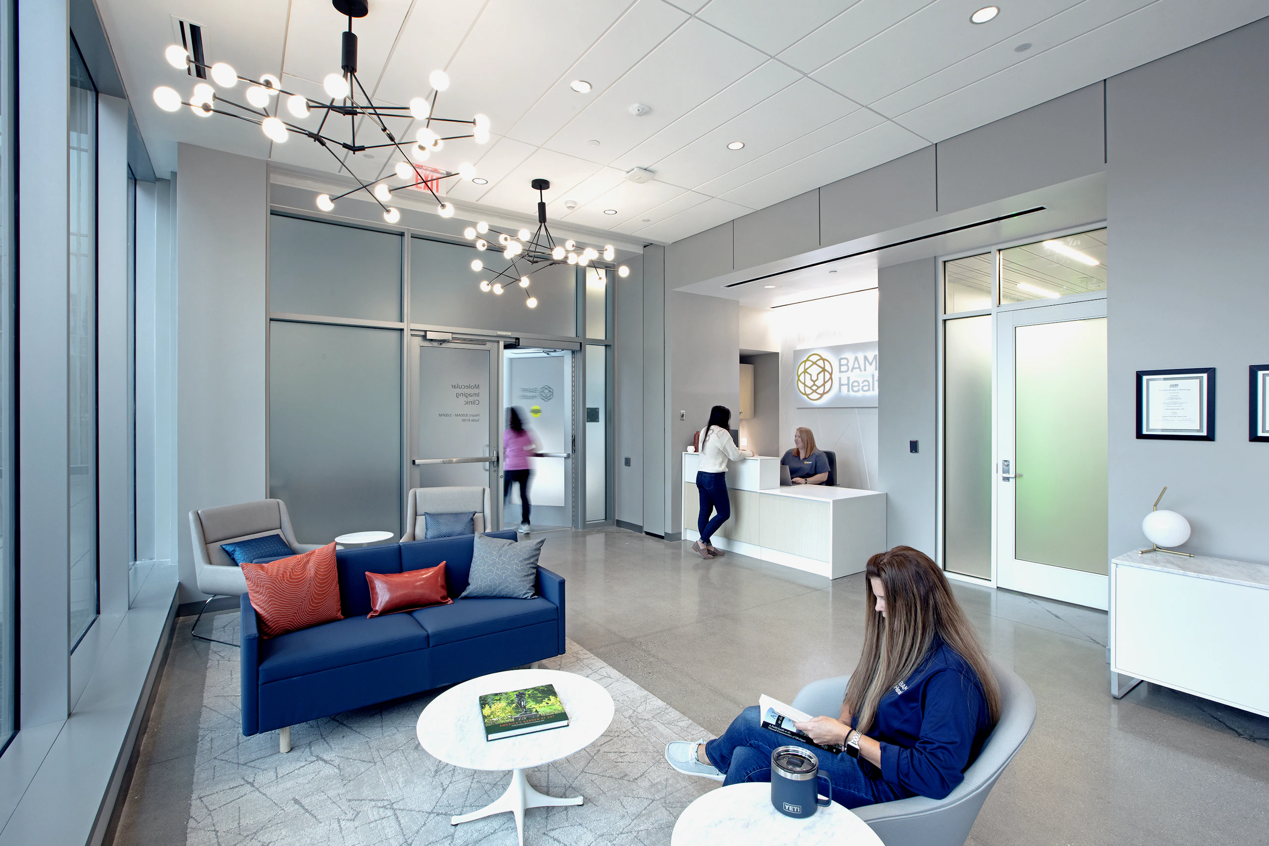 Reception and waiting area for patients with lounge seating and a reception station.
