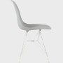 Side of light grey plastic shell chair on wire base.