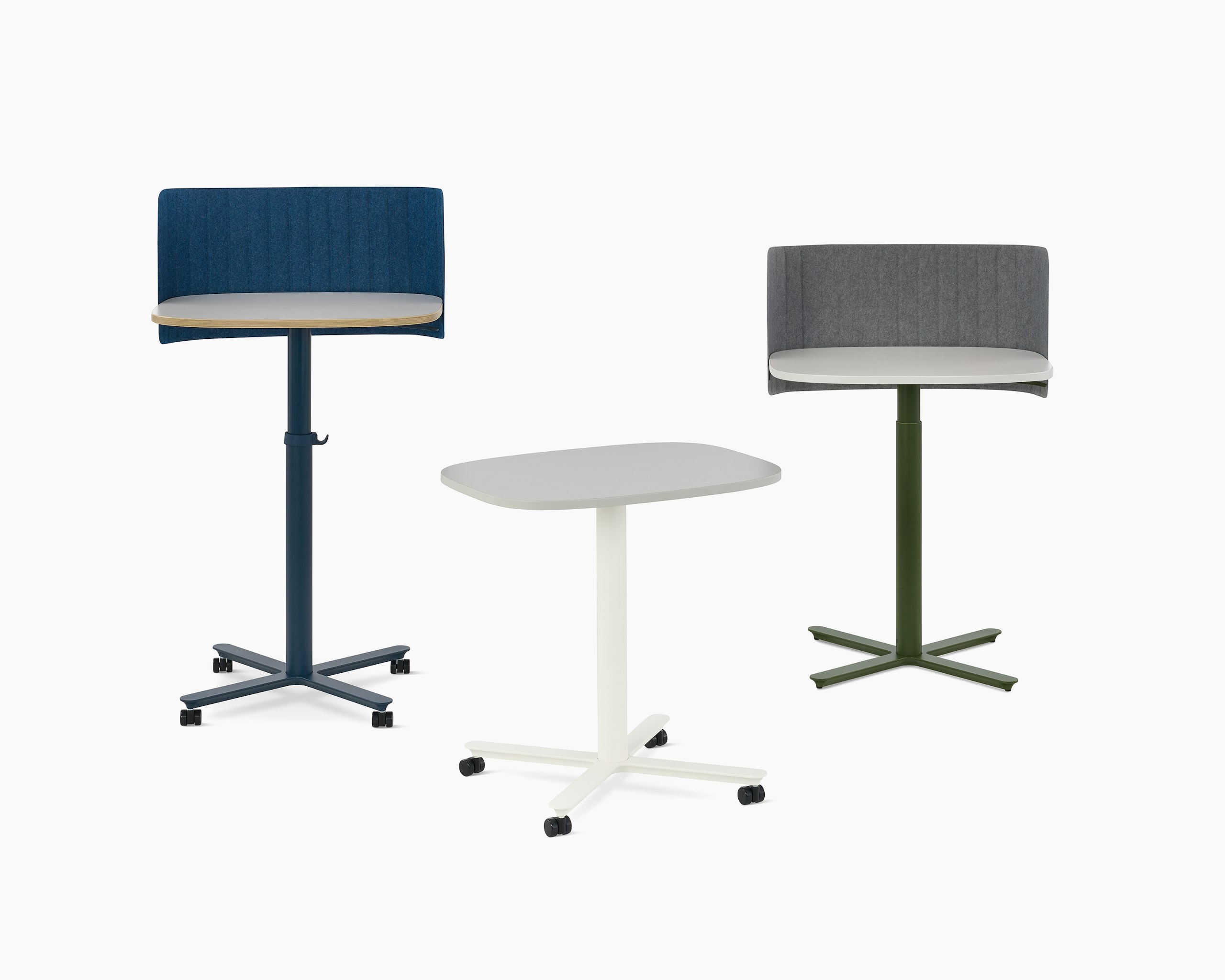 Multiple large Passport Work Tables shown with white and light grey tops and a variety of base colors and accessories.