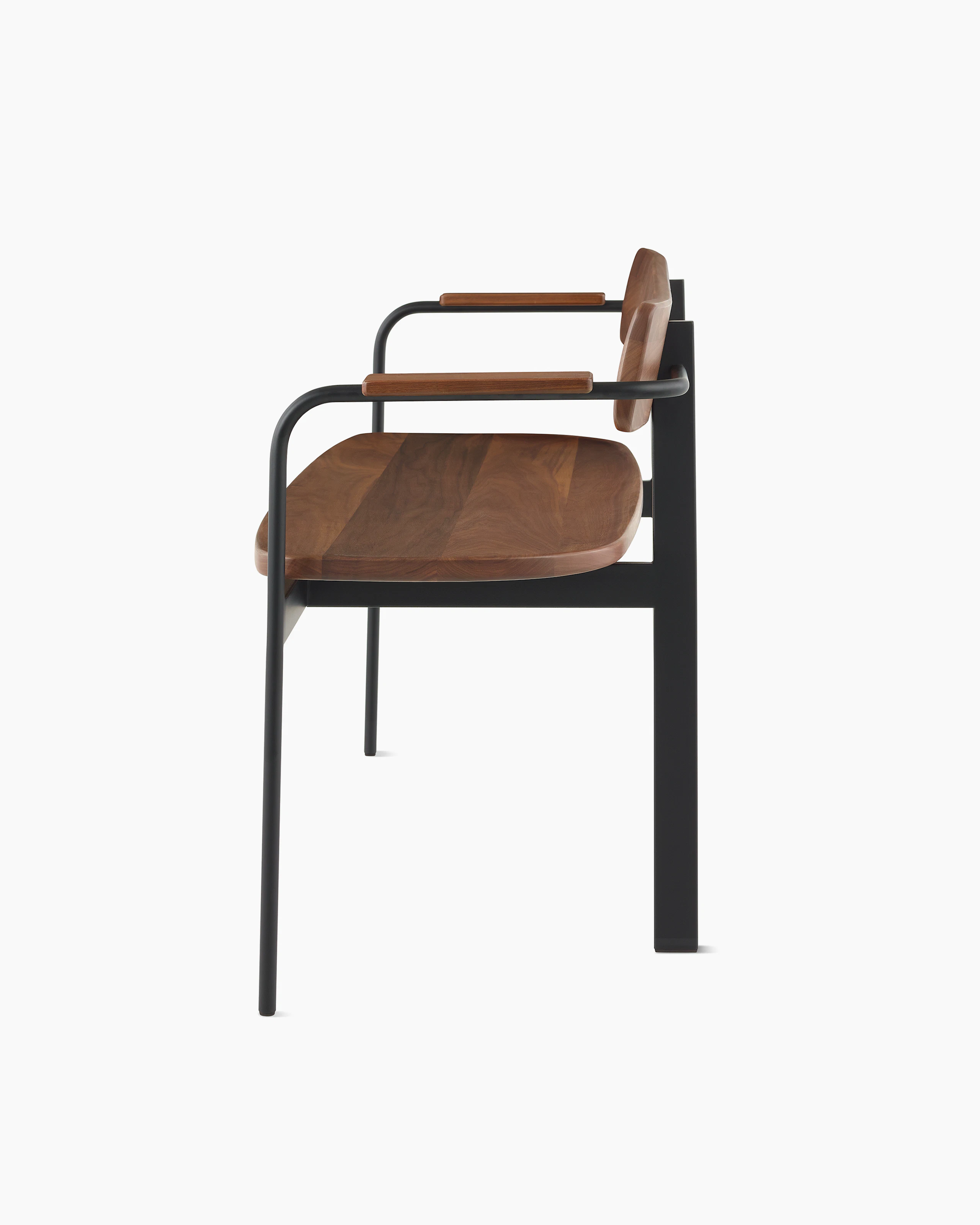A Betwixt Bench with walnut seat, backrest, and arms with a black frame.