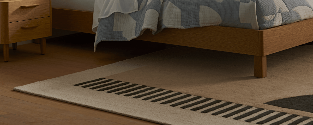 Tempo Handtufted Wool Rug under a Palm Bed in a bedroom setting