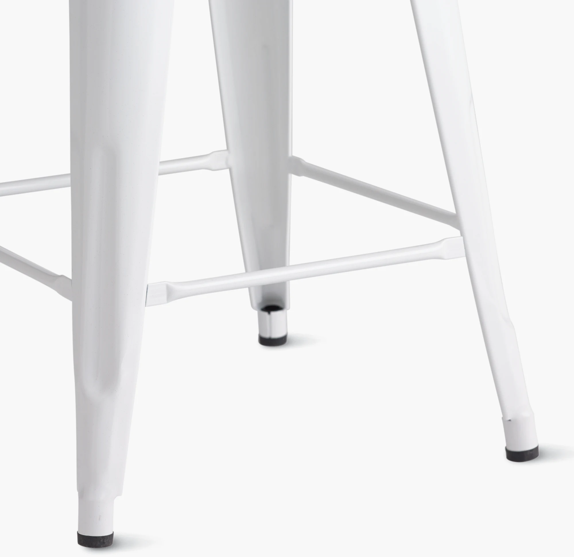 White stool legs with black floor glides detail