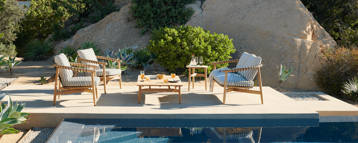 Crosshatch Outdoor Sofa, Chairs, and Table at a poolside setting