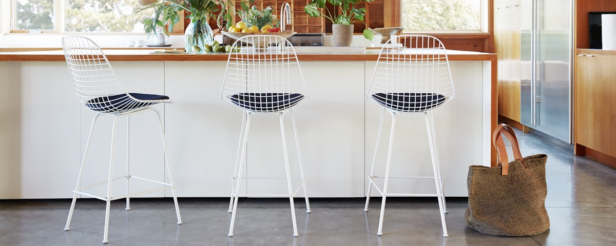 Eames Wire Stools at a kitchen counter setting