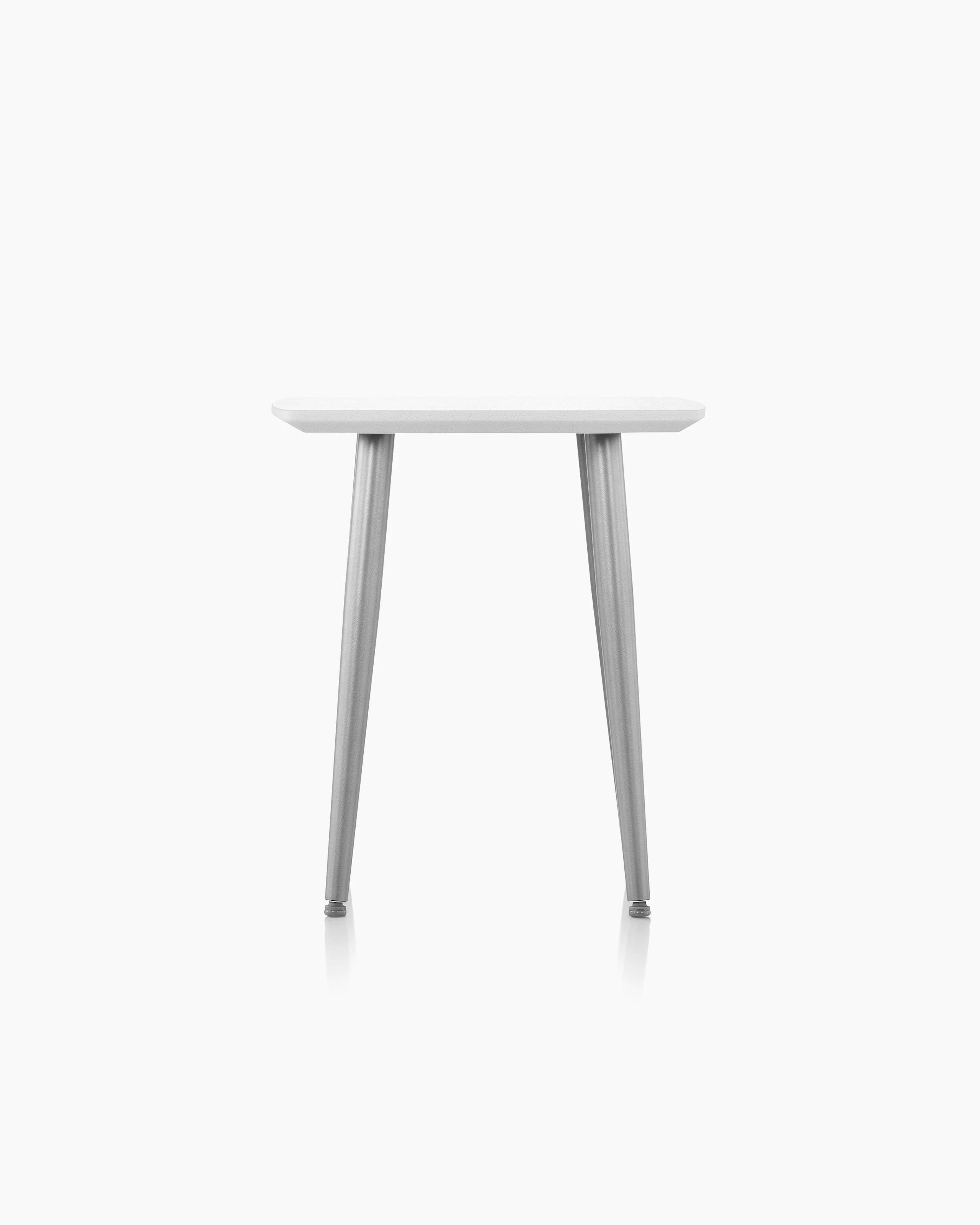Palisade Occasional Table with metal legs and solid surface top on white sweep.