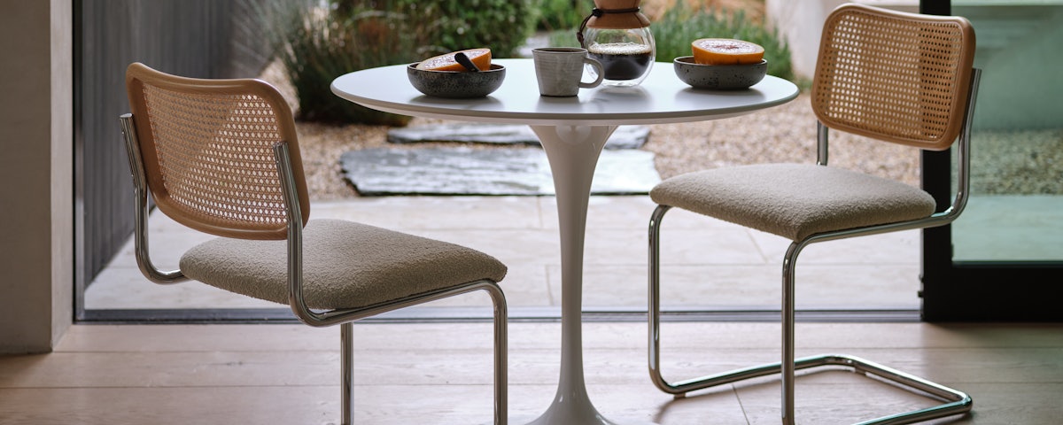 Two Cesca Side Chairs at a Saarinen Round Dining Table in a breakfast nook setting