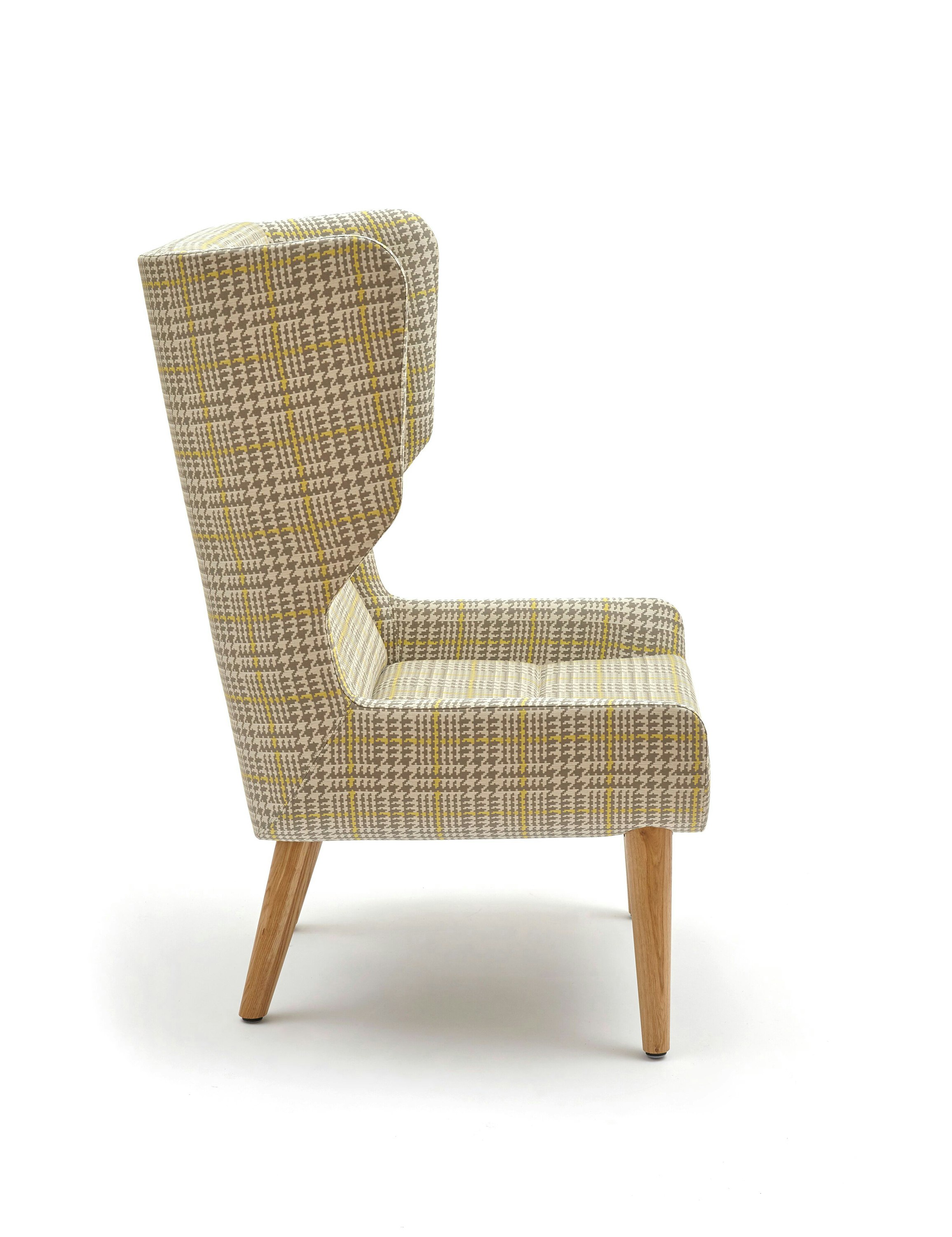 An off-white Hush Chair with a gray and yellow pattern and wooden base, viewed from the side.