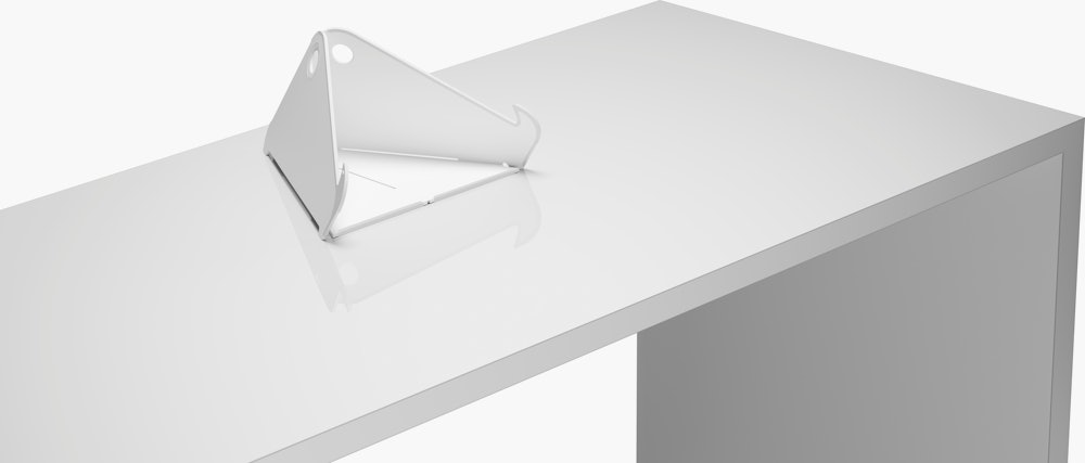 Raised and angled view of an open Oripura Laptop Stand placed on top of a worksurface.
