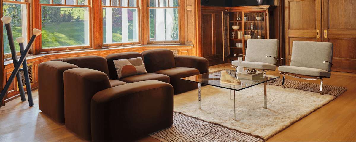 Borderline Wool Moroccan Rug under a Muse Sectional and Tugendhat Chair in a living room setting