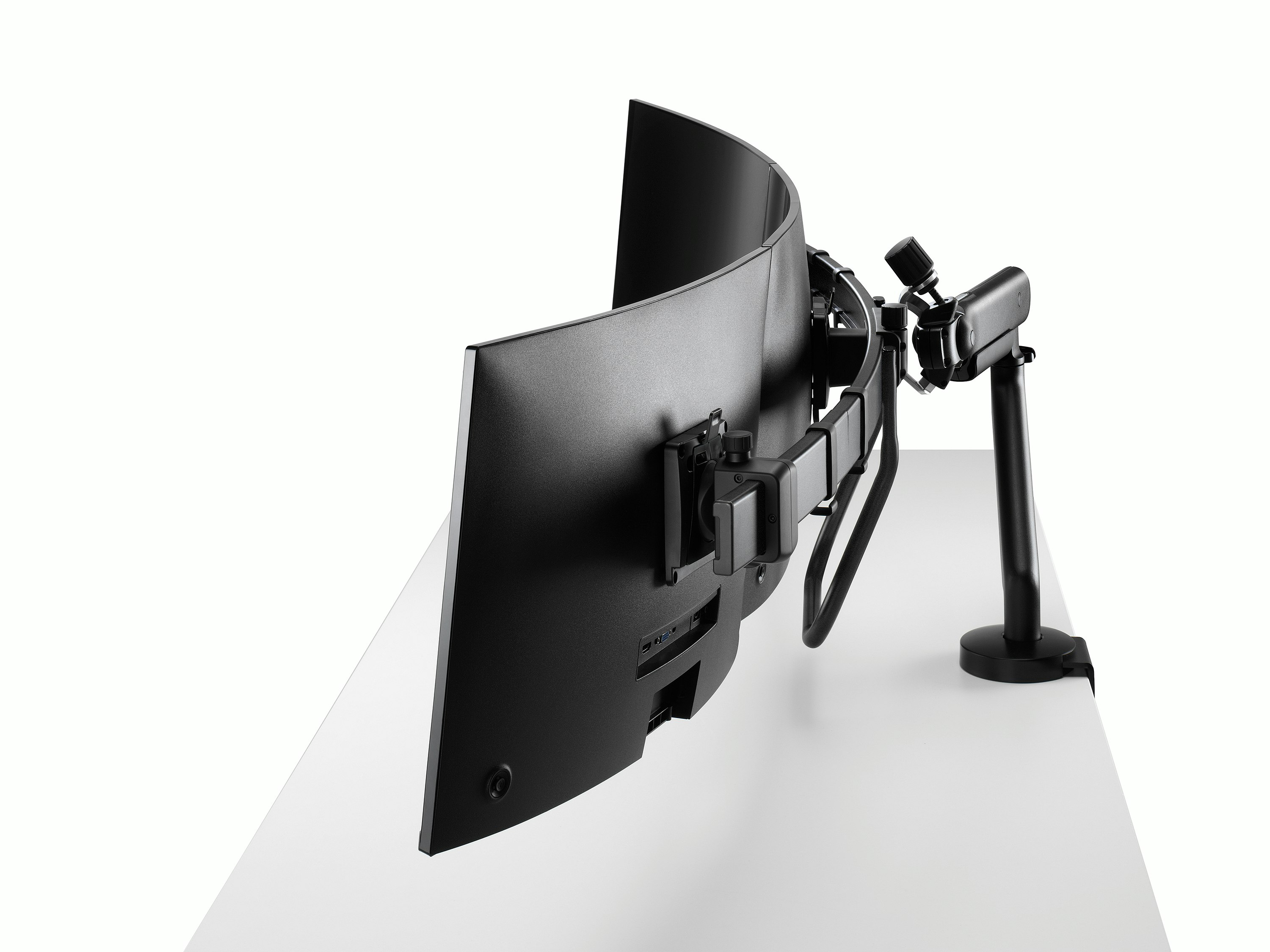 Black Flo X triple monitor arm set up, viewed from the side