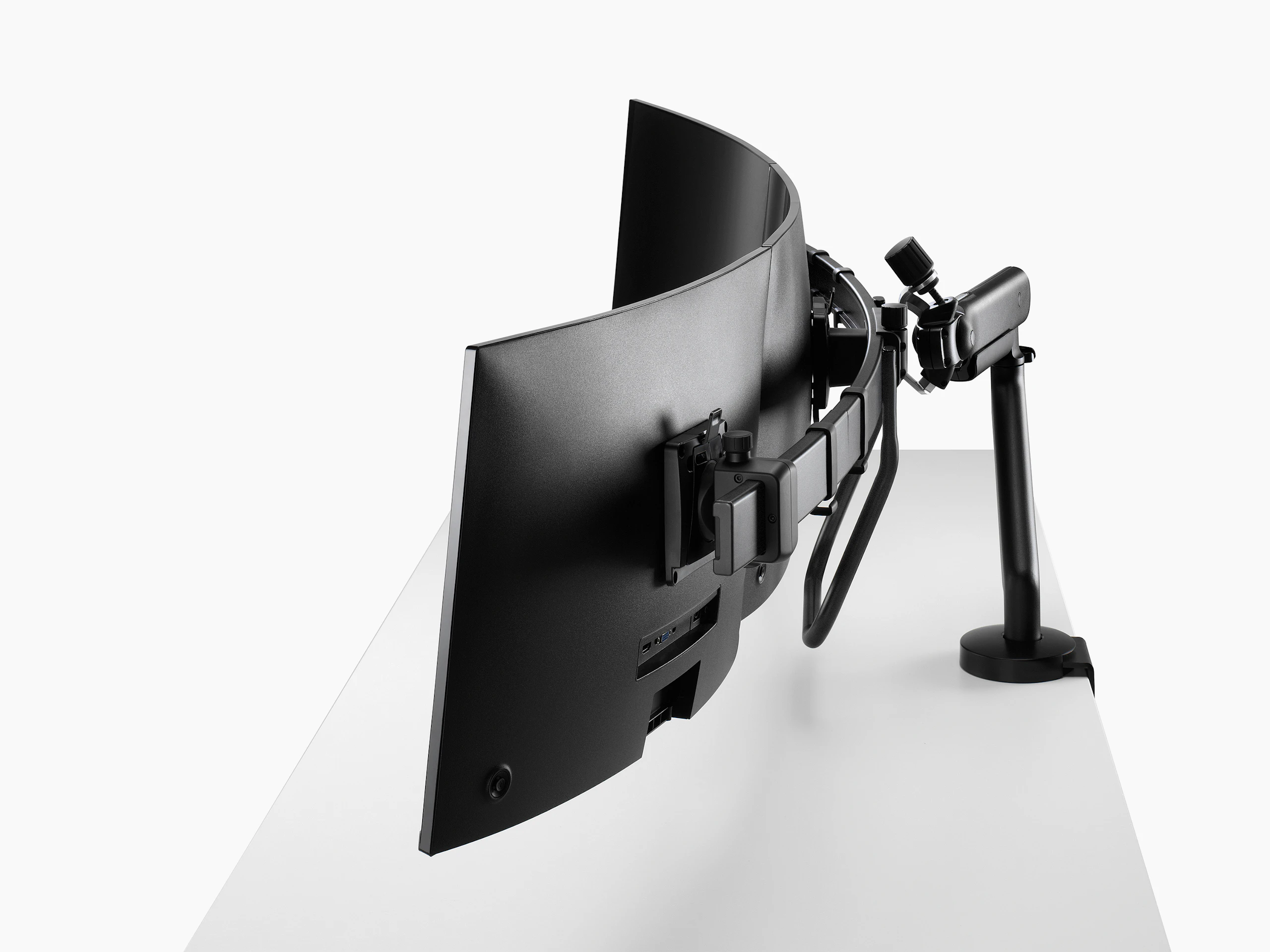 Black Flo X triple monitor arm set up, viewed from the side