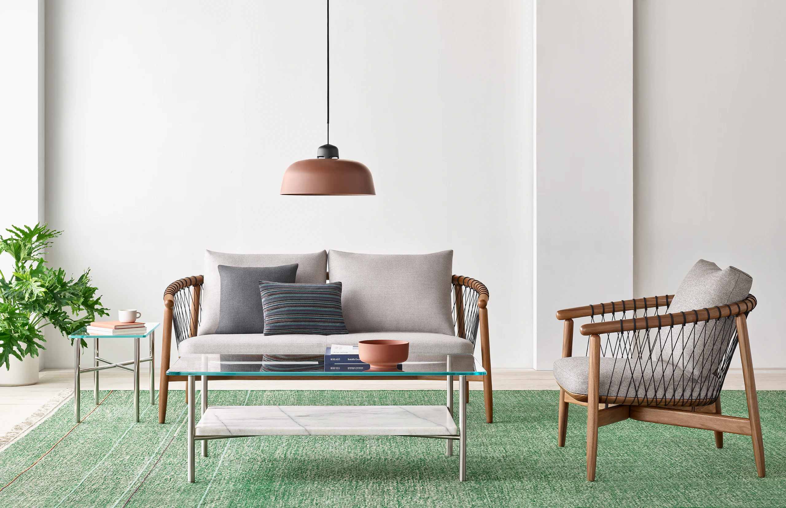 A casual lounge setting with a Layer Table anchoring a Crosshatch Settee and Crosshatch Chair.