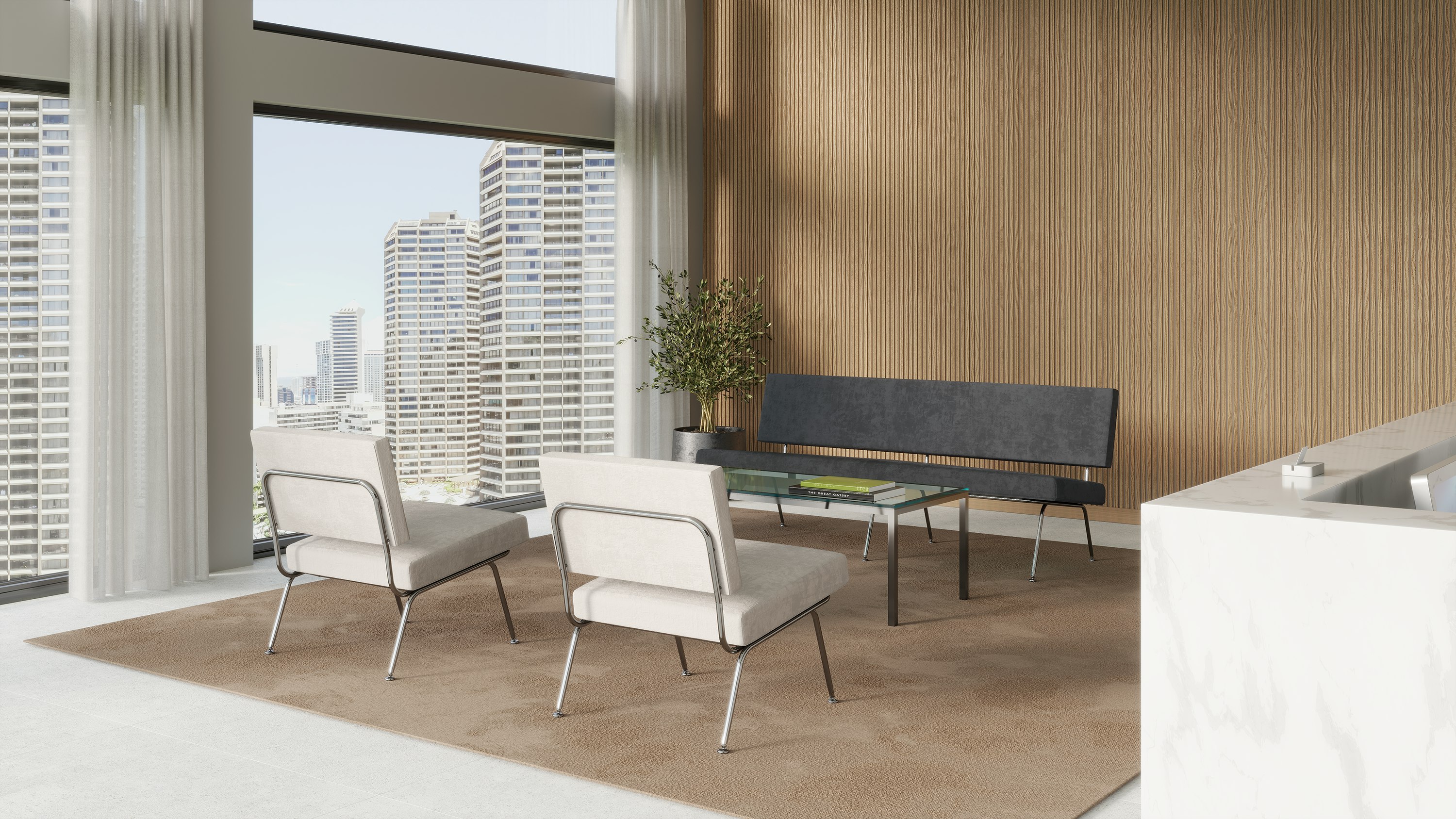 A bright reception area with two Florence Knoll Model 31 chairs and a grey Florence Knoll Model 33 sofa.