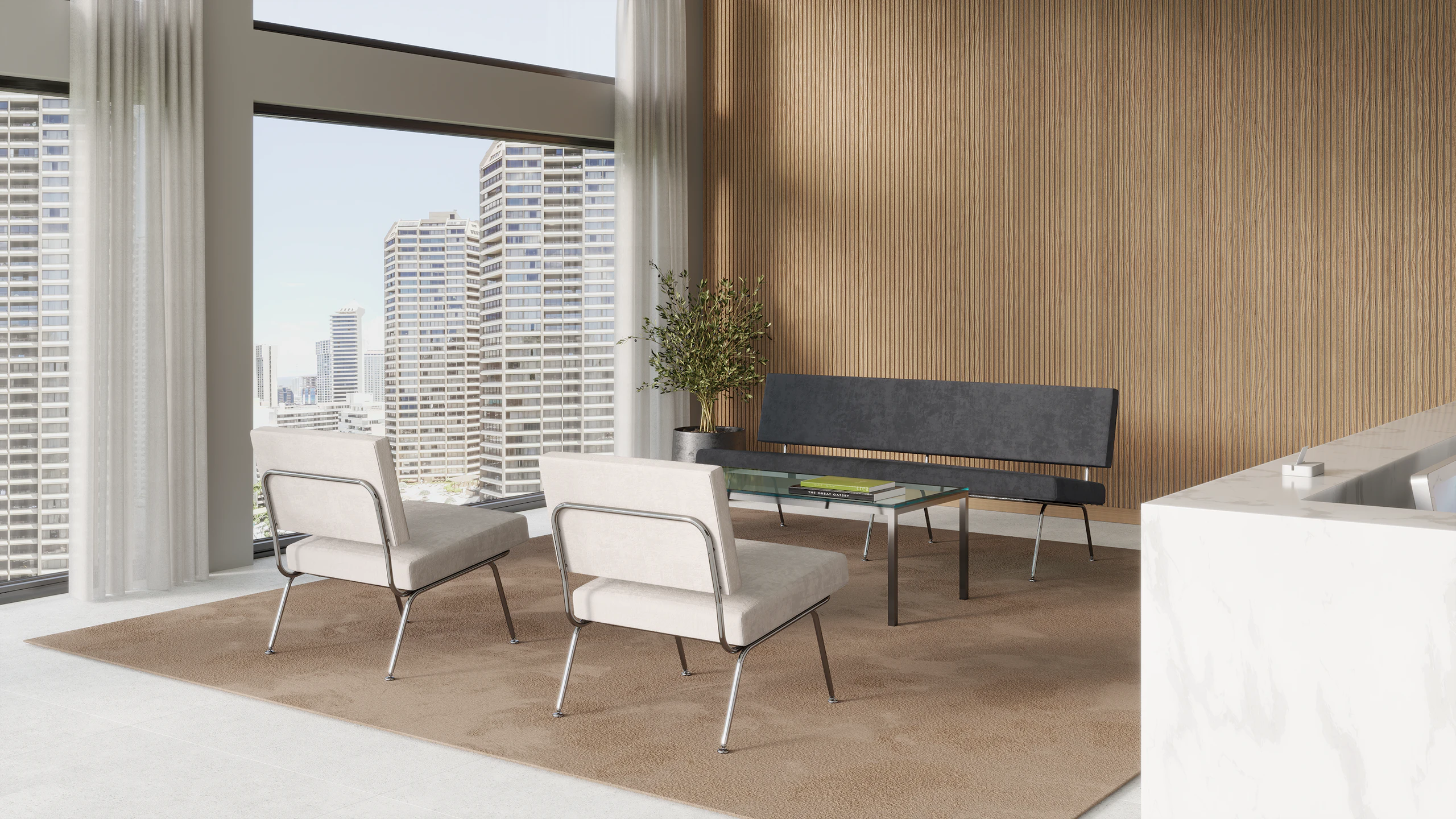 A bright reception area with two Florence Knoll Model 31 chairs and a grey Florence Knoll Model 33 sofa.
