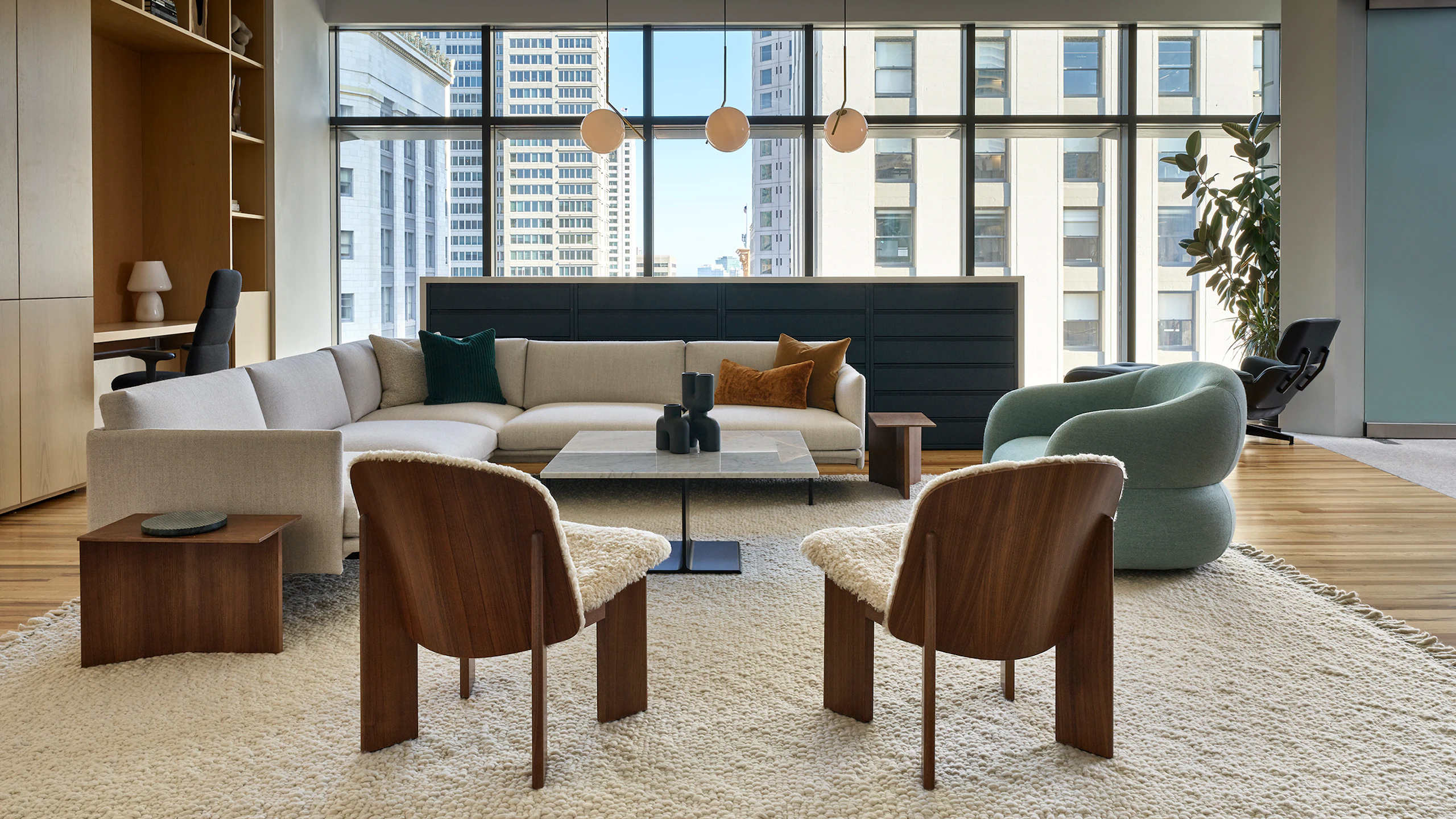A Knoll Risom Lounge Chair, marble Krusin Coffee Table, Muuto Pouf, Outline Sofa, and Cosy Table Lamp at the Knoll San Francisco showroom
