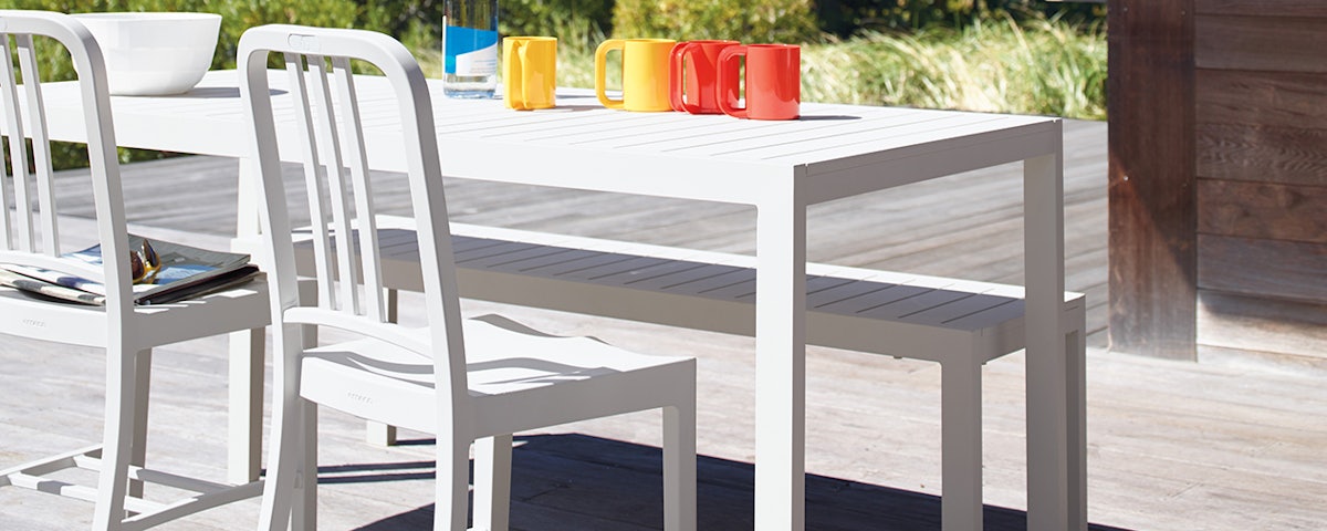 Two 111 Navy Chairs on an outdoor deck
