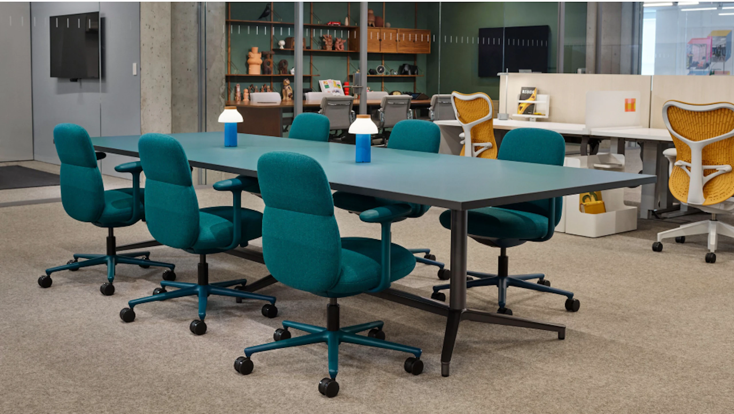 Several Asari Chairs by Herman Miller arranged around a large table at the Herman Miller Fulton Market showroom in Chicago