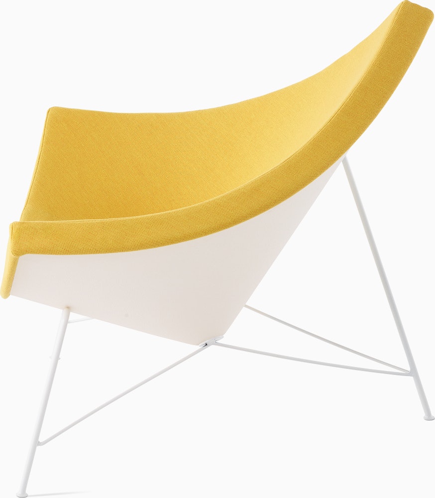 Profile view of  Nelson Coconut  Lounge Chair in a yellow Mode fabric.