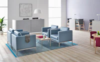 A well-lit waiting room featuring Riva lounge chairs in blue textile with brushed metal legs and Monarch Easy Access Chairs.