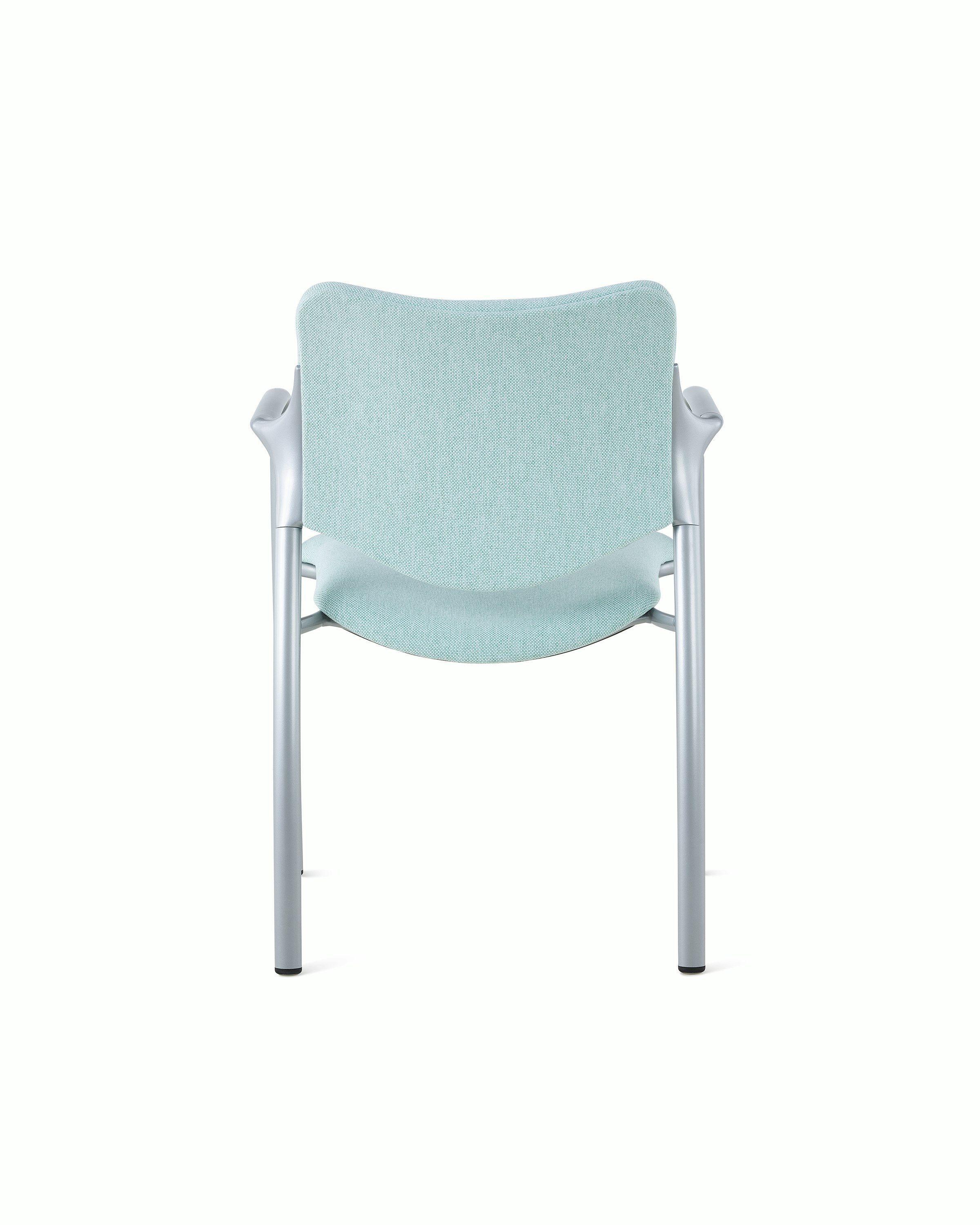 An Aside Chair with light green upholstered seat and back, viewed from the back.