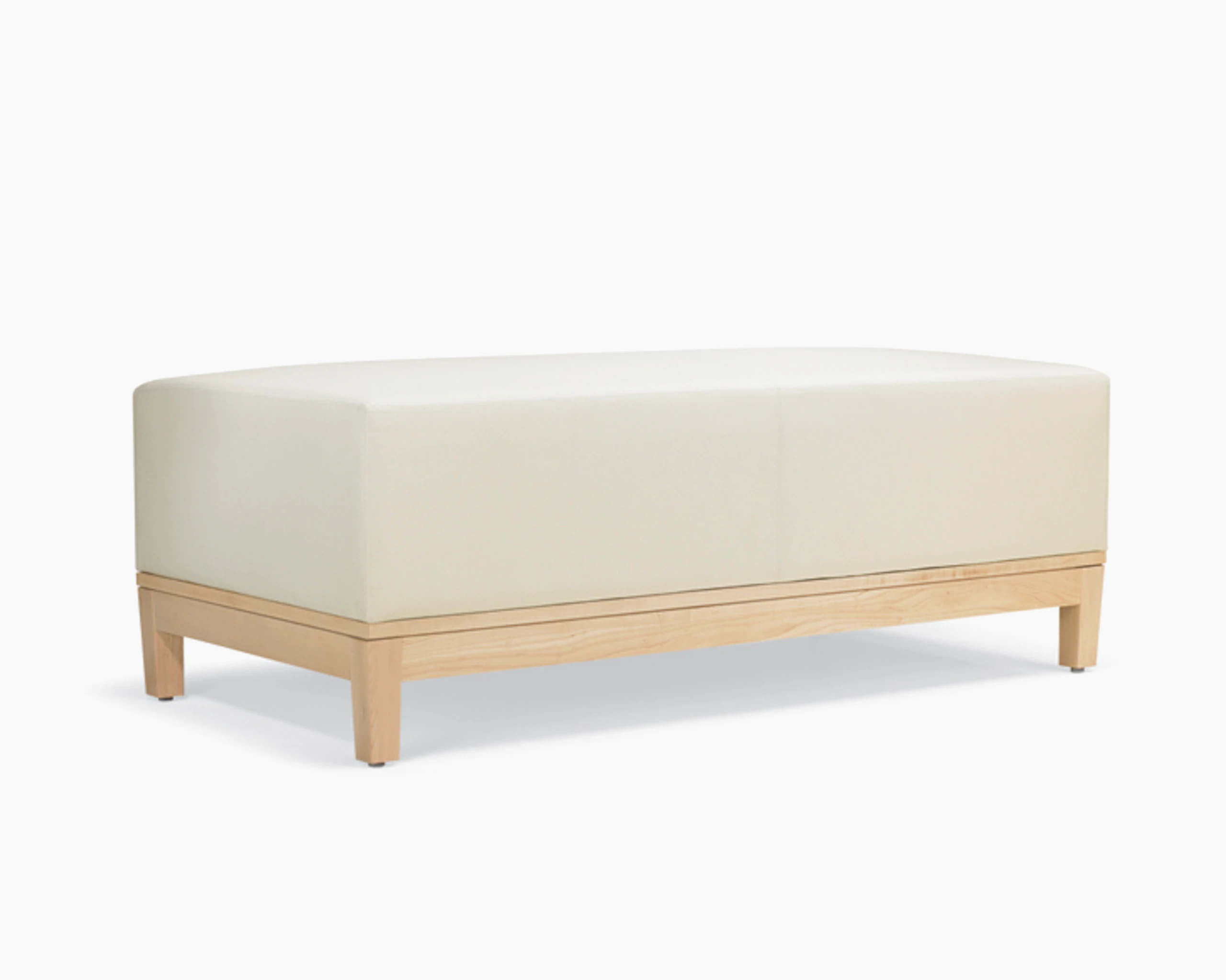 A three-quarter view of a Brava Platform Lounge Bench with maple base and white textile.