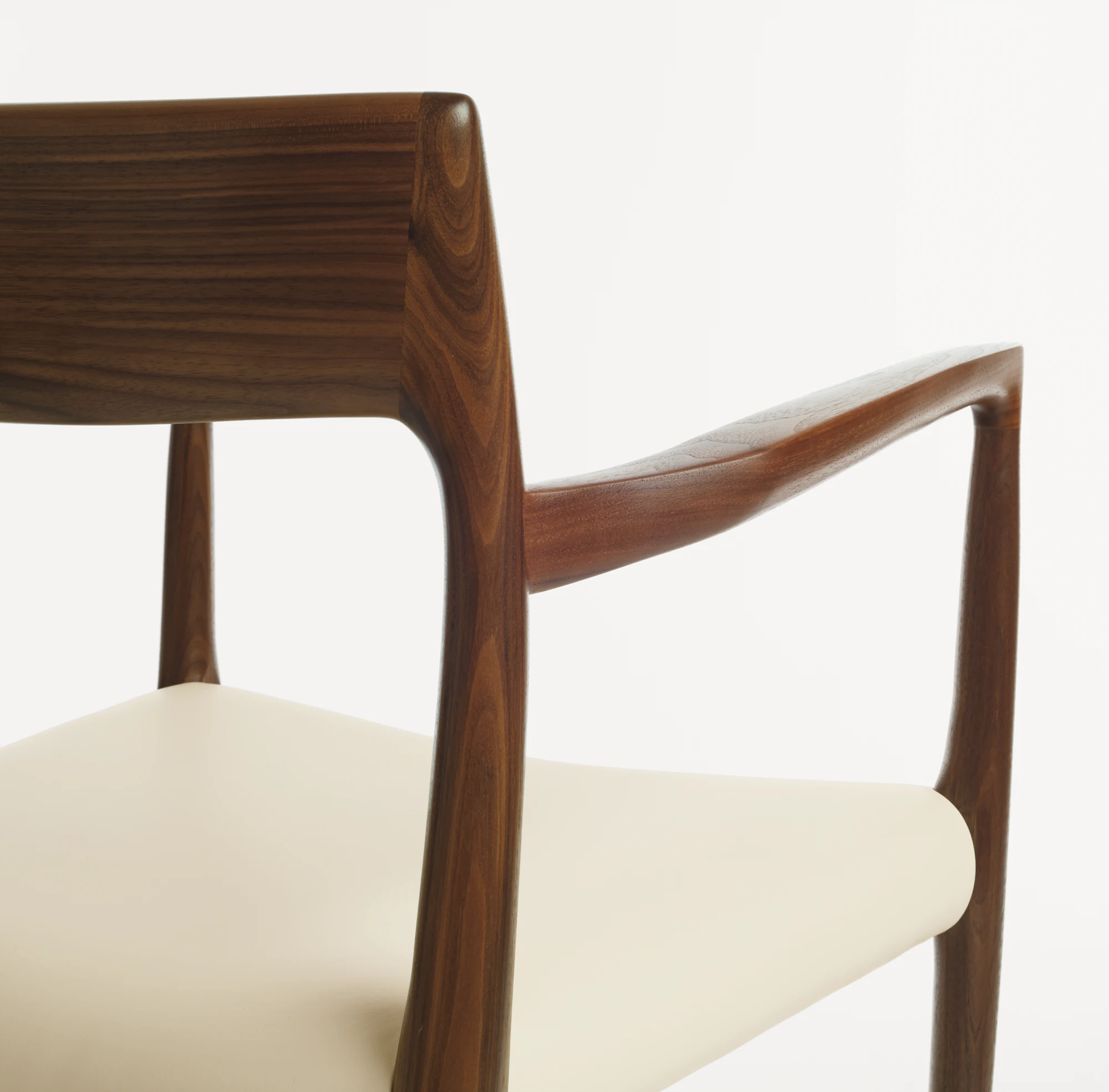 Moller Model 57 armchair with ivory leather seat and walnut arm frame detail