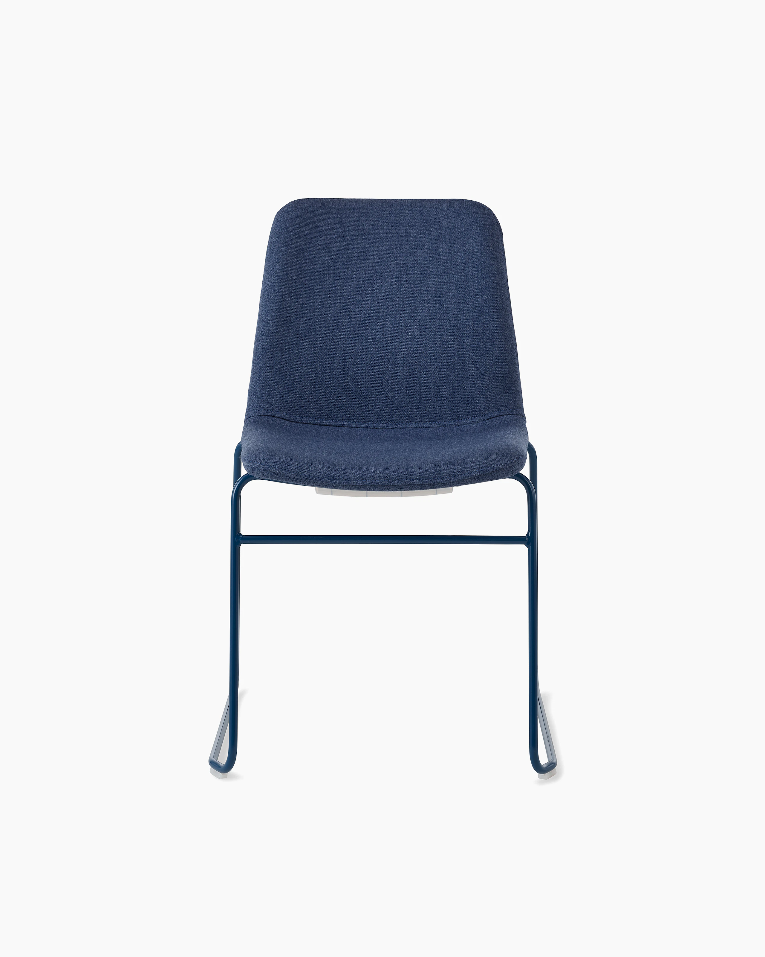 White sweep of Viv chair with dark blue fabric and dark blue steel sled base