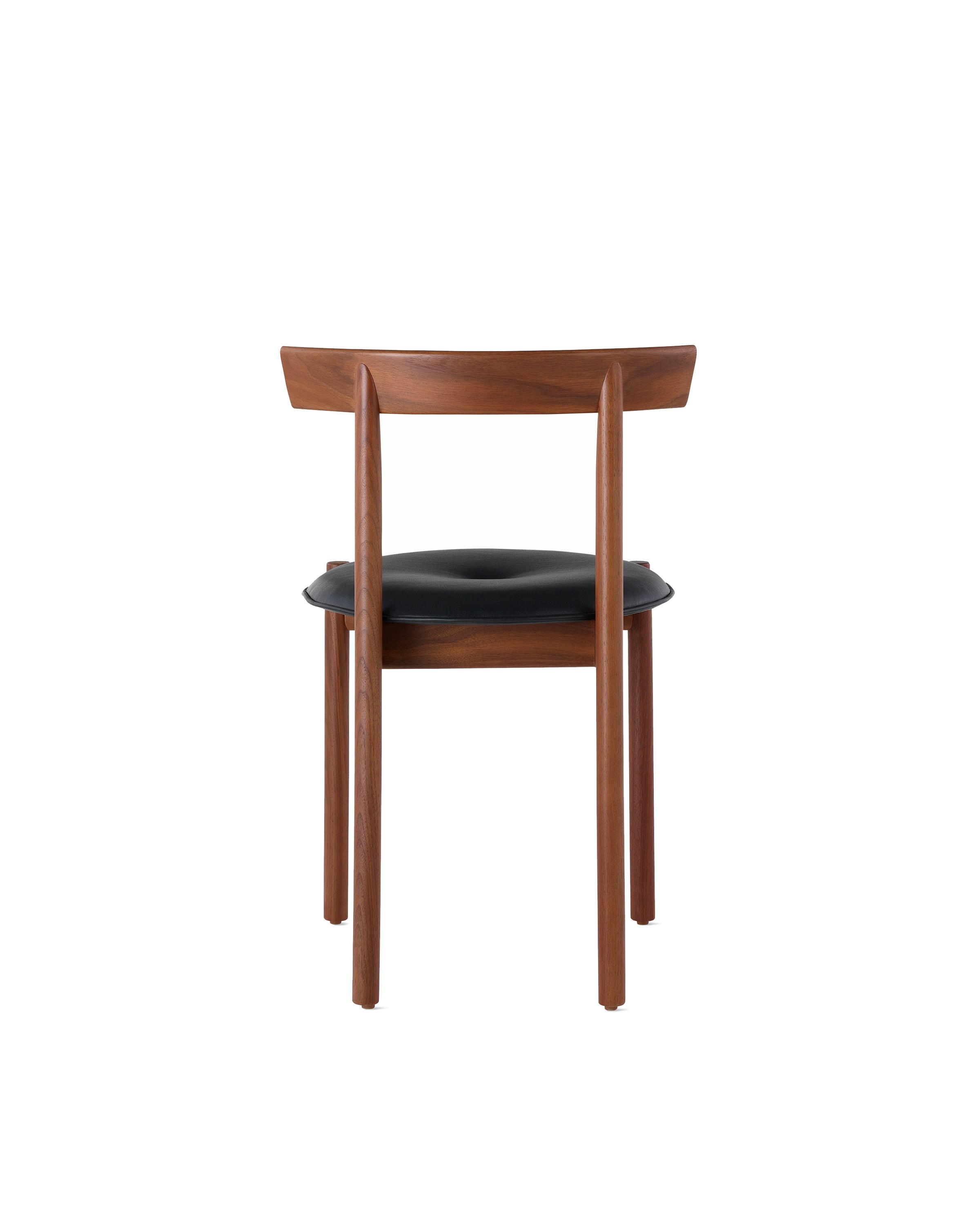 A walnut Comma Chair with a seat pad, viewed from the back.