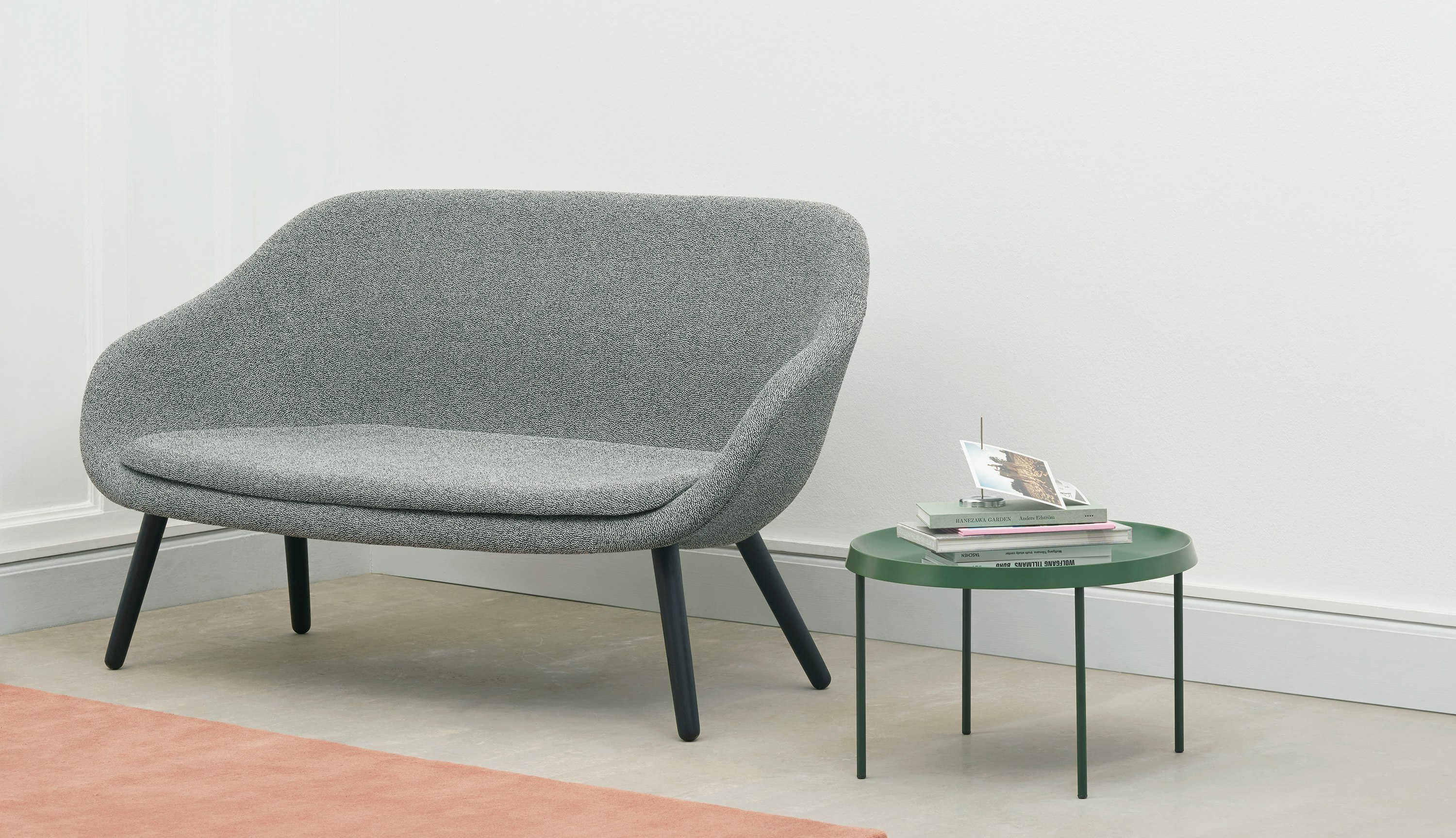 A grey About A Lounge Sofa next to a green table.