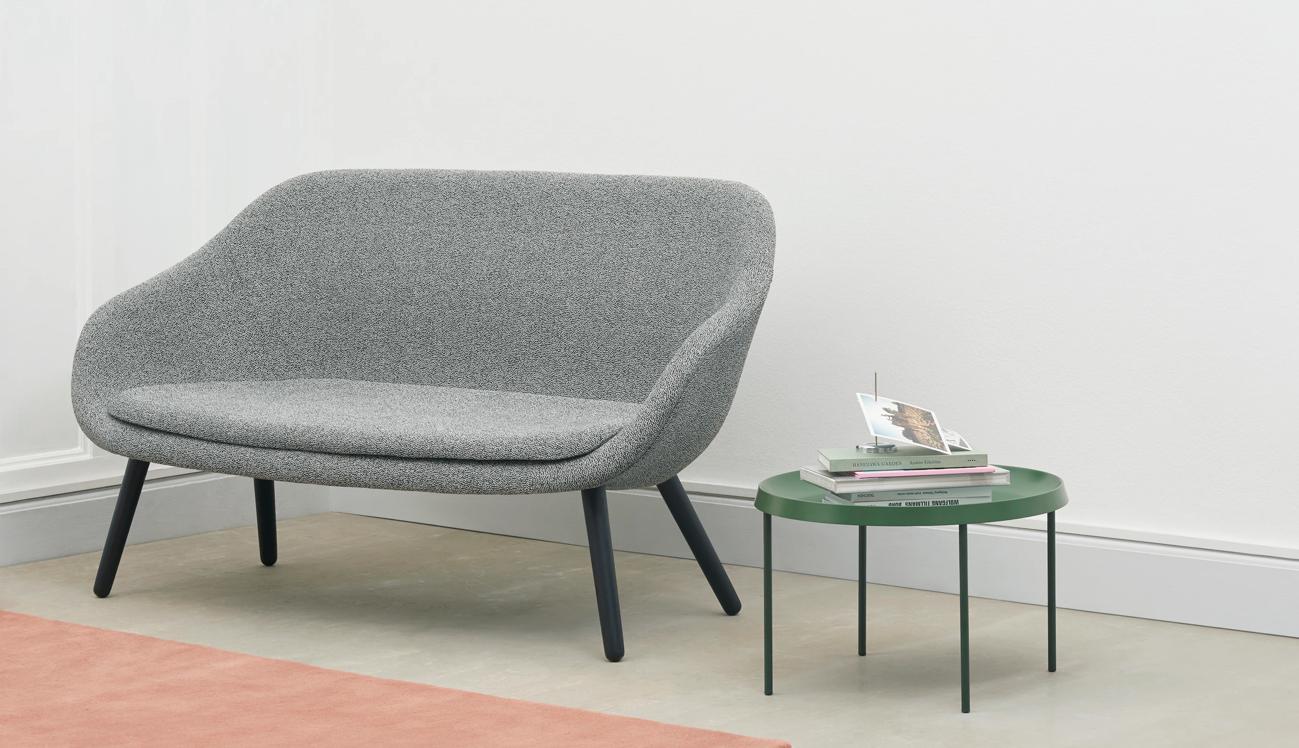 A grey About A Lounge Sofa next to a green table.