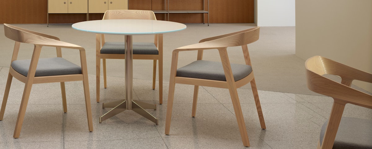 Three Full Twist Armchairs surrounding a small dining table