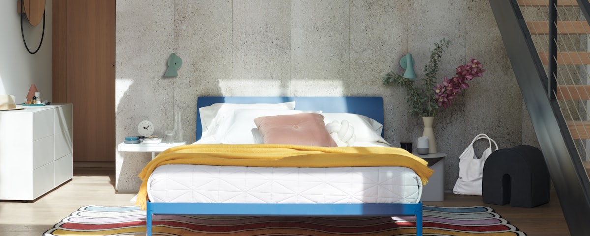 AJ Wall Sconces over a Min Bed with Headboard in a bedroom setting