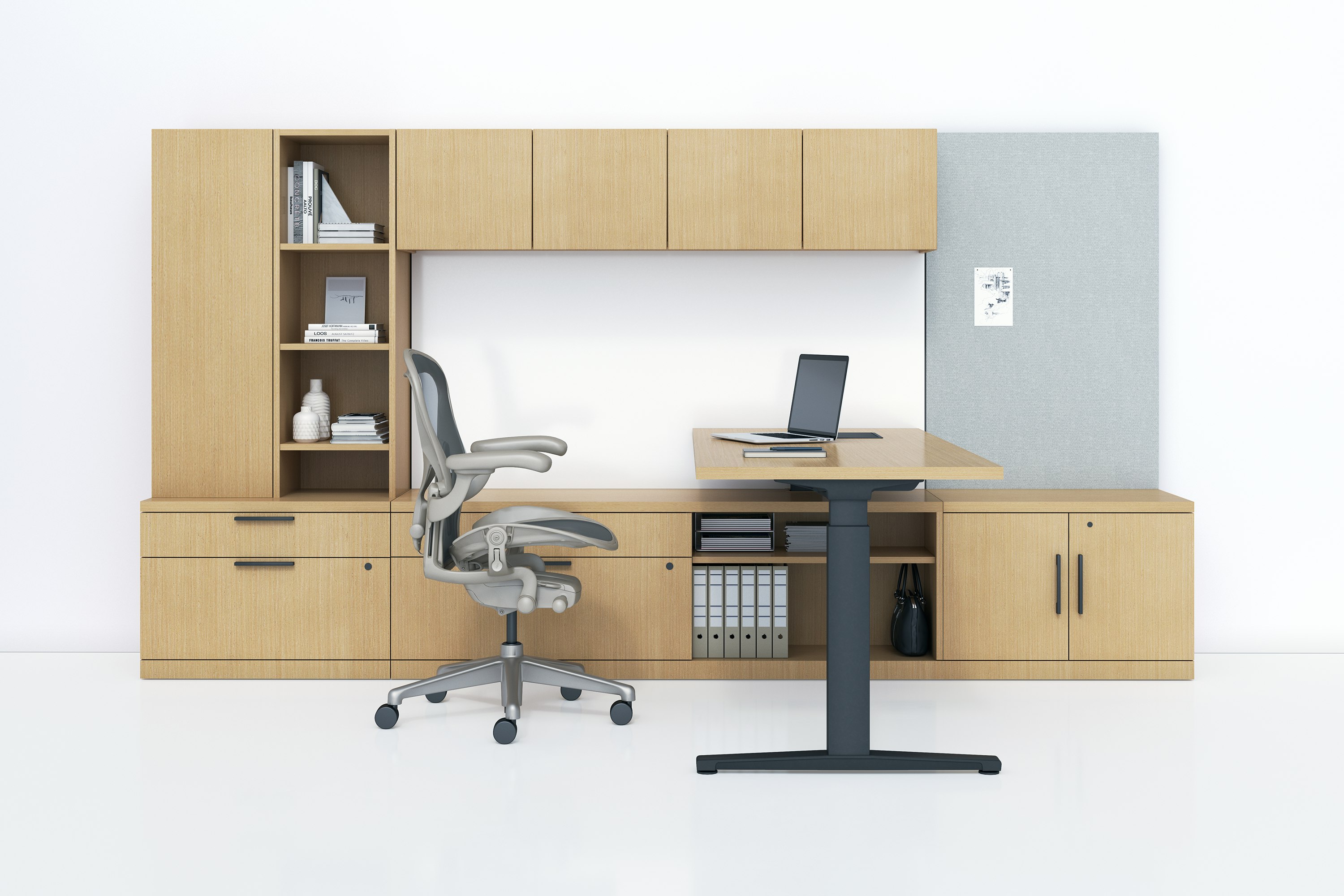 A Canvas Private Office with light wood storage, height adjustable desk, and light grey Aeron chair.