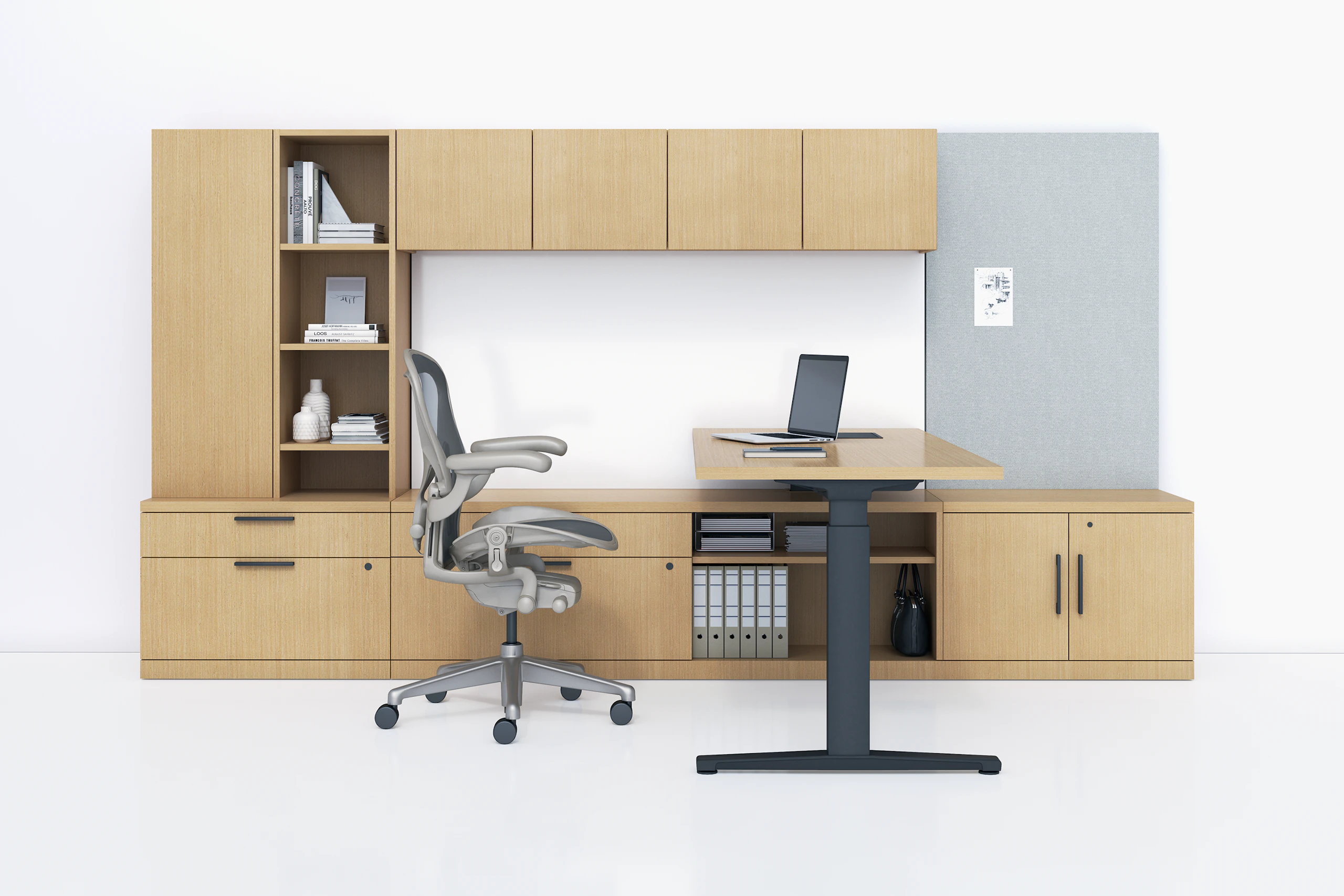 A Canvas Private Office with light wood storage, height adjustable desk, and light grey Aeron chair.
