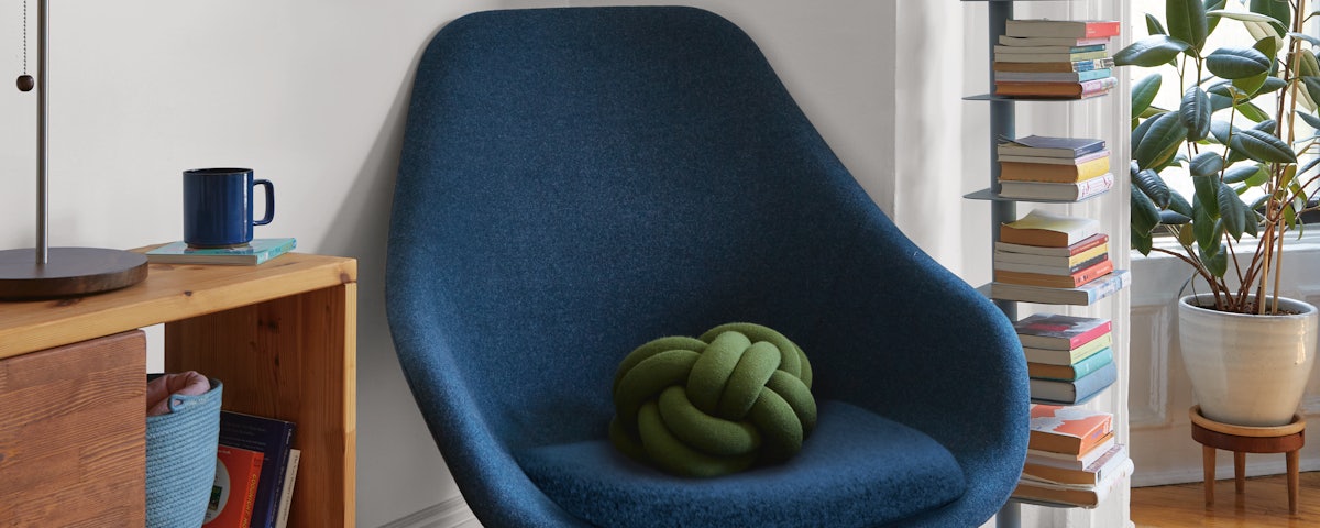 About A Lounge 92 Armchair with a Knot Cushion and Story Bookcase in a living room setting