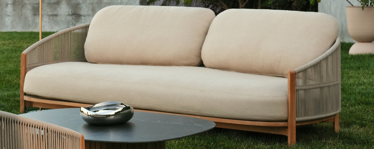 Softlands Outdoor Sofa and Coffee Table in an outdoor lawn setting