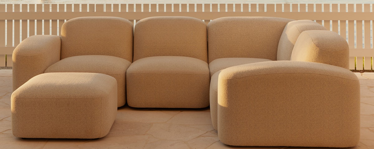 Muse Outdoor Ottoman and Muse Outdoor Corner Sofa in an outdoor patio setting
