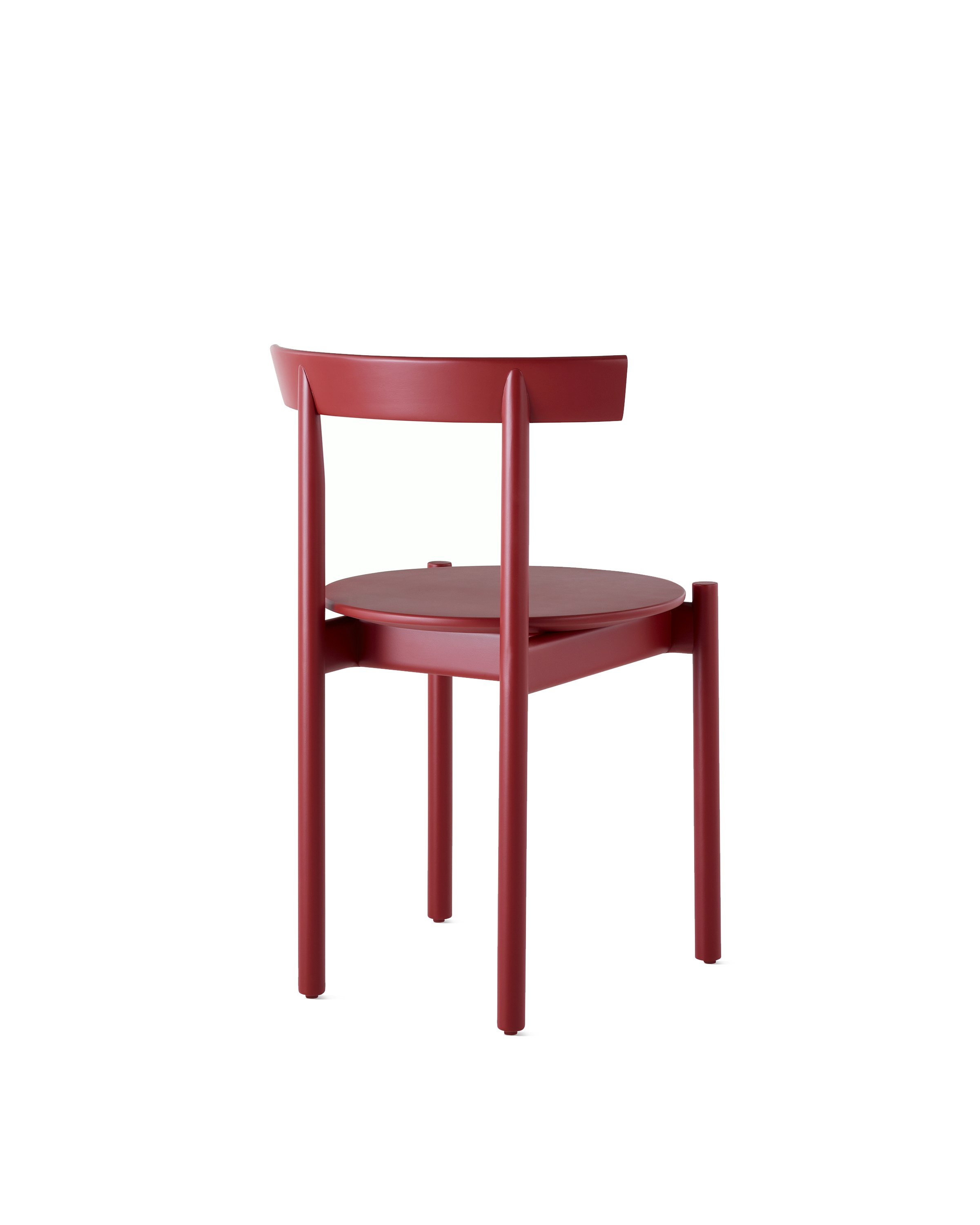 A red Comma Chair, viewed from the back at an angle.