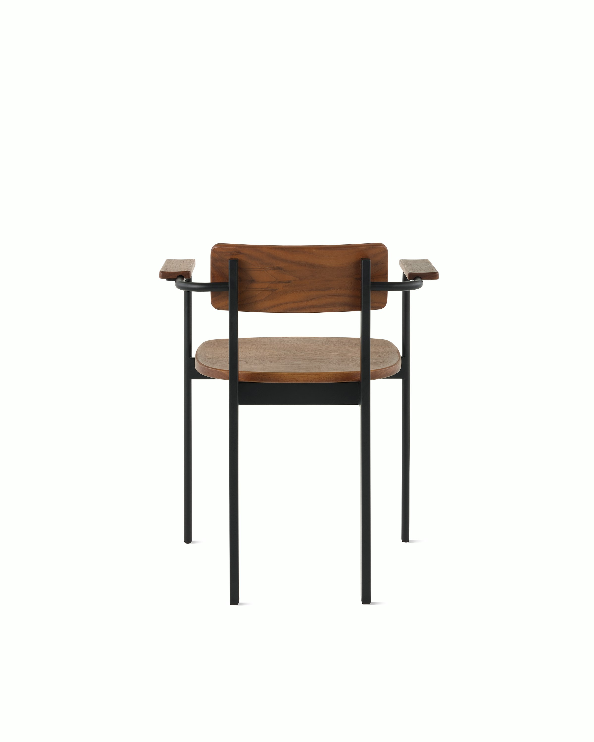 A Betwixt Chair with a walnut backrest, seat, and arms with a black frame.