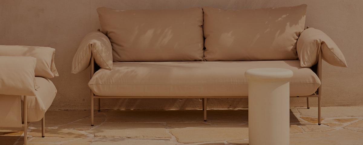 Sarah Ellison Alva Outdoor Sofa in a courtyard setting