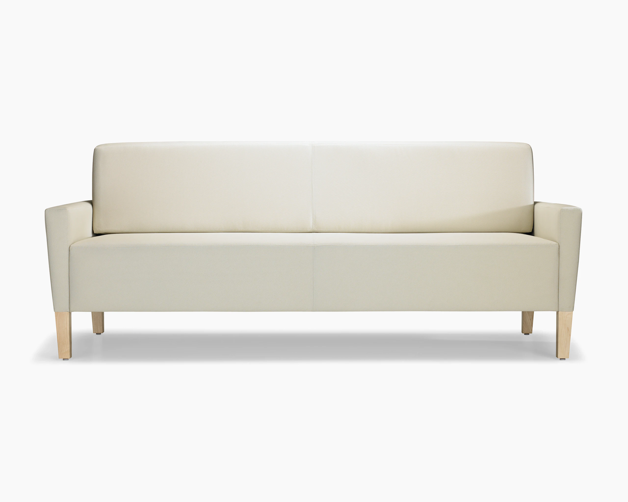 A front view of a Brava Flop Sofa in white textile with maple legs.