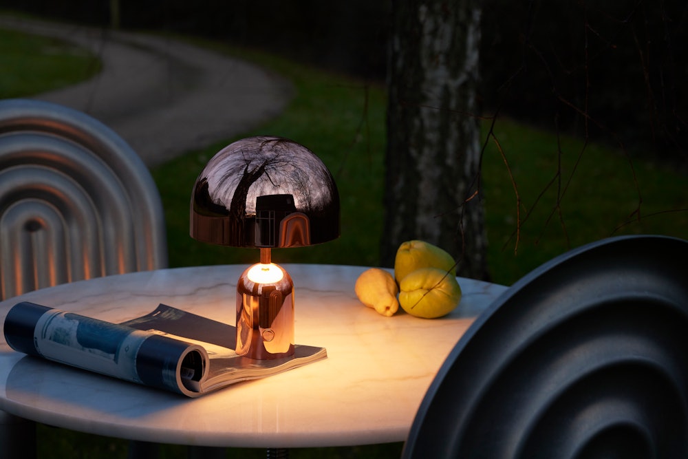 Bell Portable Lamp on a outdoor cafe table at night