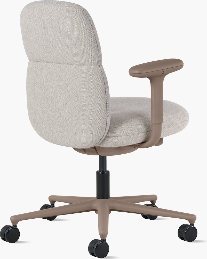 Rear  angle view of a mid-back Asari chair by Herman Miller in light brown with height adjustable arms.