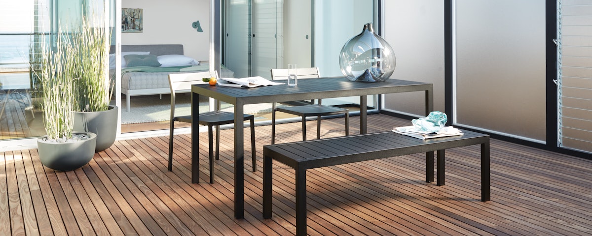 Eos Dining Table and Eos Dining Benches in an outdoor patio setting