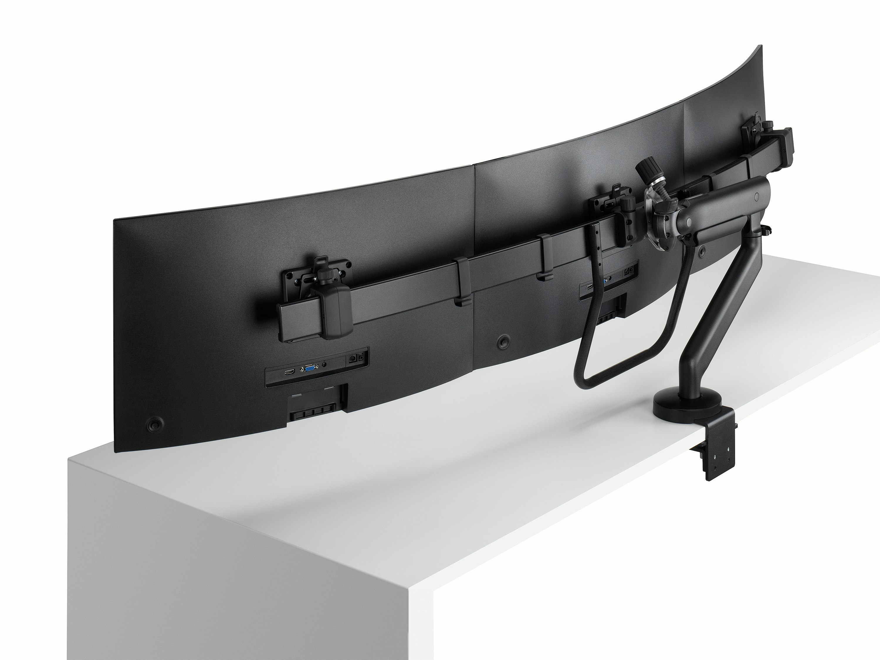 Black Flo X triple monitor arm set up with 27'' screens, viewed from the side-back