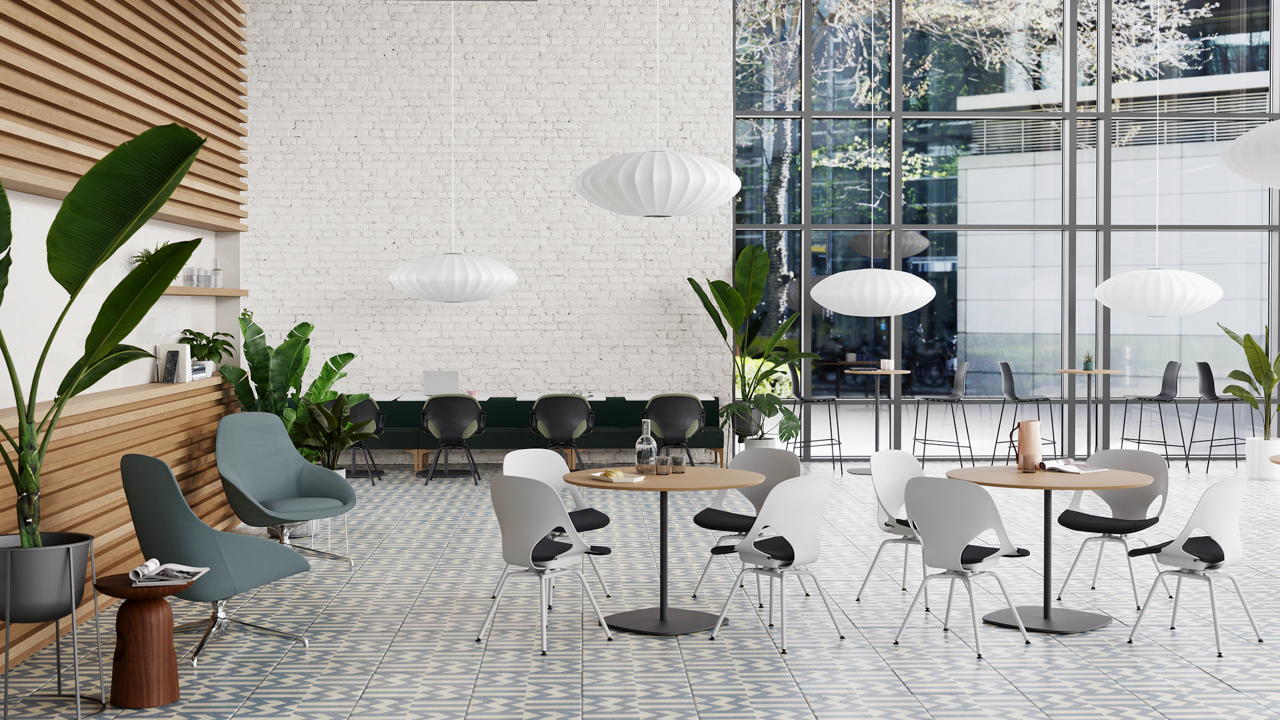 A Café that features light grey Zeph side chairs with a dark brown knit seat pad around round cafe tables, and a long modular sofa bordered with black Zeph side chairs with a green seat pad.
